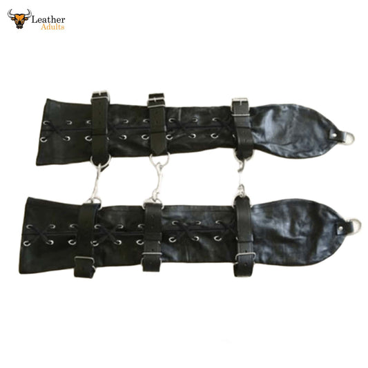 This image shows a pair of black leather arm restraints, designed for adults. Each restraint features multiple straps with buckles for adjustability, as well as lacing details along the length. Metal D-rings or similar attachments are visible at the ends and along the sides, suggesting they can be connected or secured. The overall appearance is robust and functional.