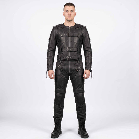 Full length front view of athletic man wearing handmade black cowhide leather restraint suit with front buckle straps, padded knees, and combat boots