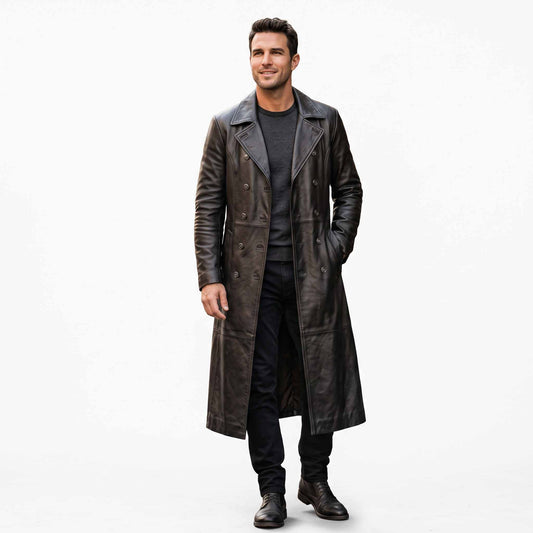 Full length front studio view of handsome smiling man wearing handmade black real leather double breasted trench coat on white background