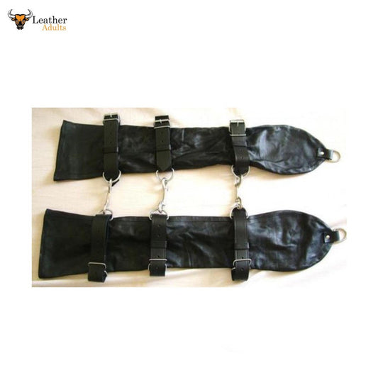 A pair of black leather bondage gloves with straps and metal D-rings.