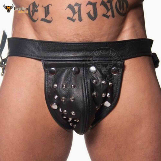 This image features a men's fetish underwear designed with a rugged, edgy aesthetic. The underwear is crafted from genuine cowhide leather and includes a distinct cod-piece jockstrap design.