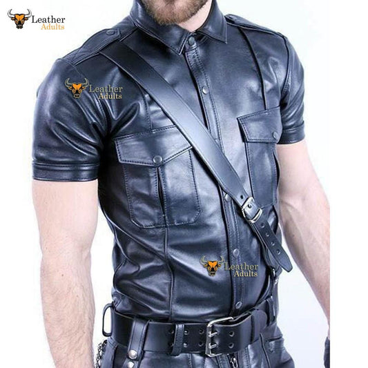 A man wearing a black leather shirt with a police motif, featuring silver press stud fastenings and a leather belt.