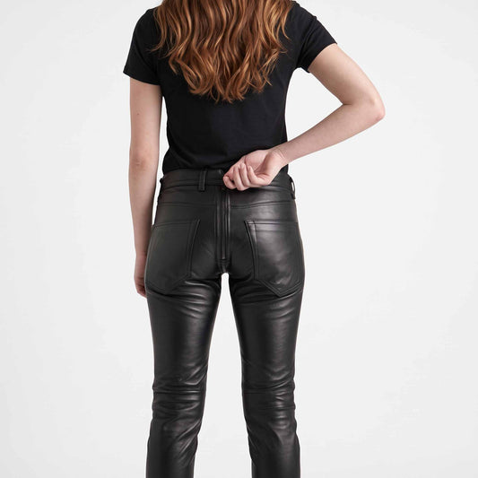 Close up view of hands unzipping the two way rear zipper on mens black cowhide leather trousers