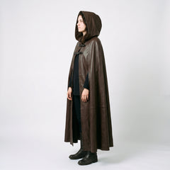 Direct side profile of woman wearing tailored brown leather fantasy ranger cloak showing full height drape and hood shape