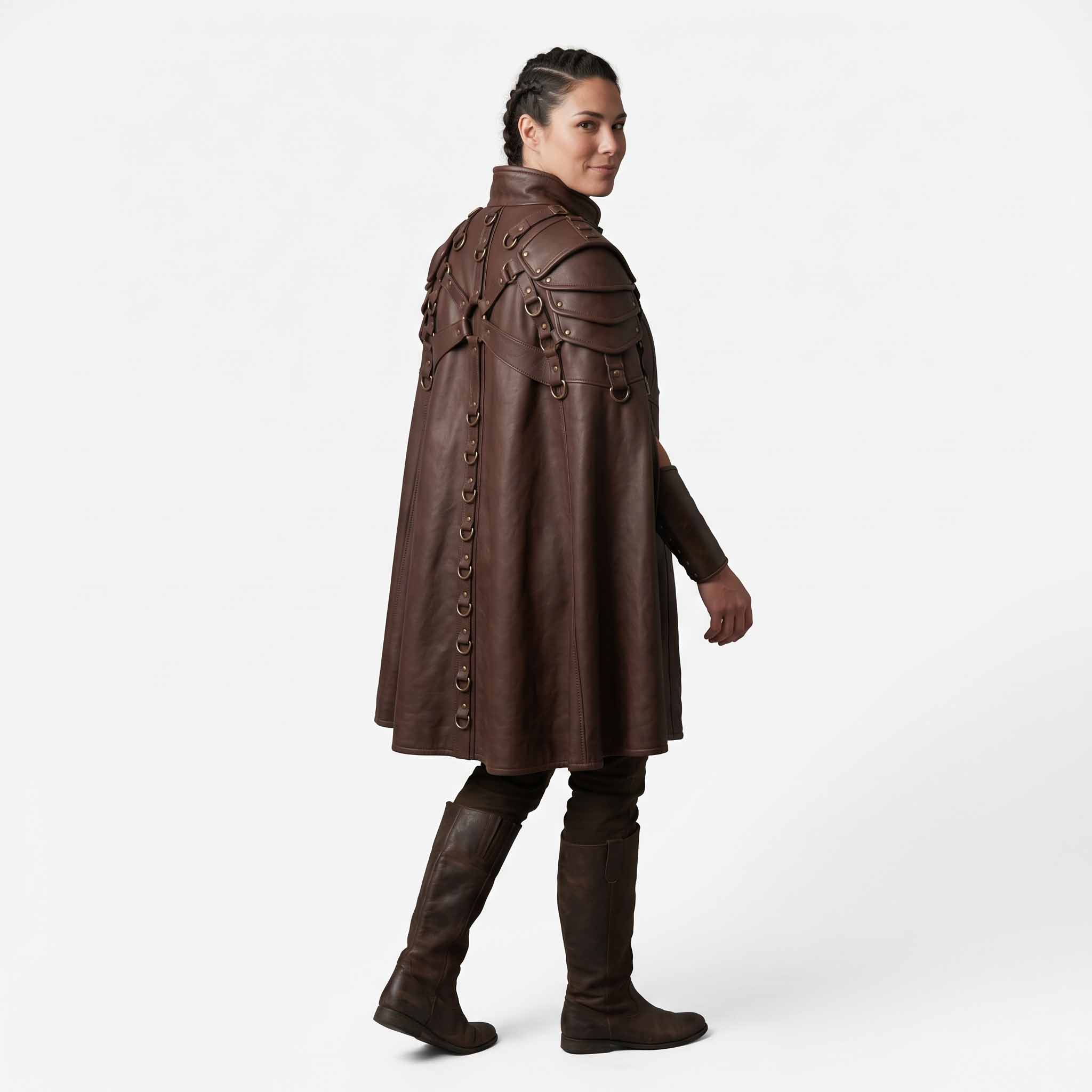 Rear three quarter angle of woman looking over shoulder wearing brown cowhide medieval cloak showing back harness and spine D rings