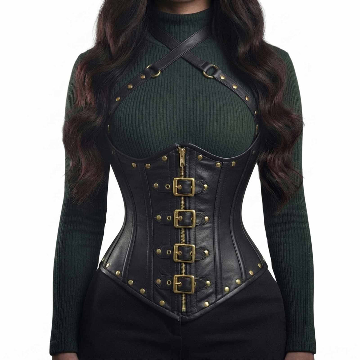 Front view of a model wearing a black genuine leather underbust harness corset with brass front buckles, center zipper, and chest straps styled over a green sweater.