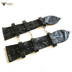 Black leather harness with metal rings on a white background
