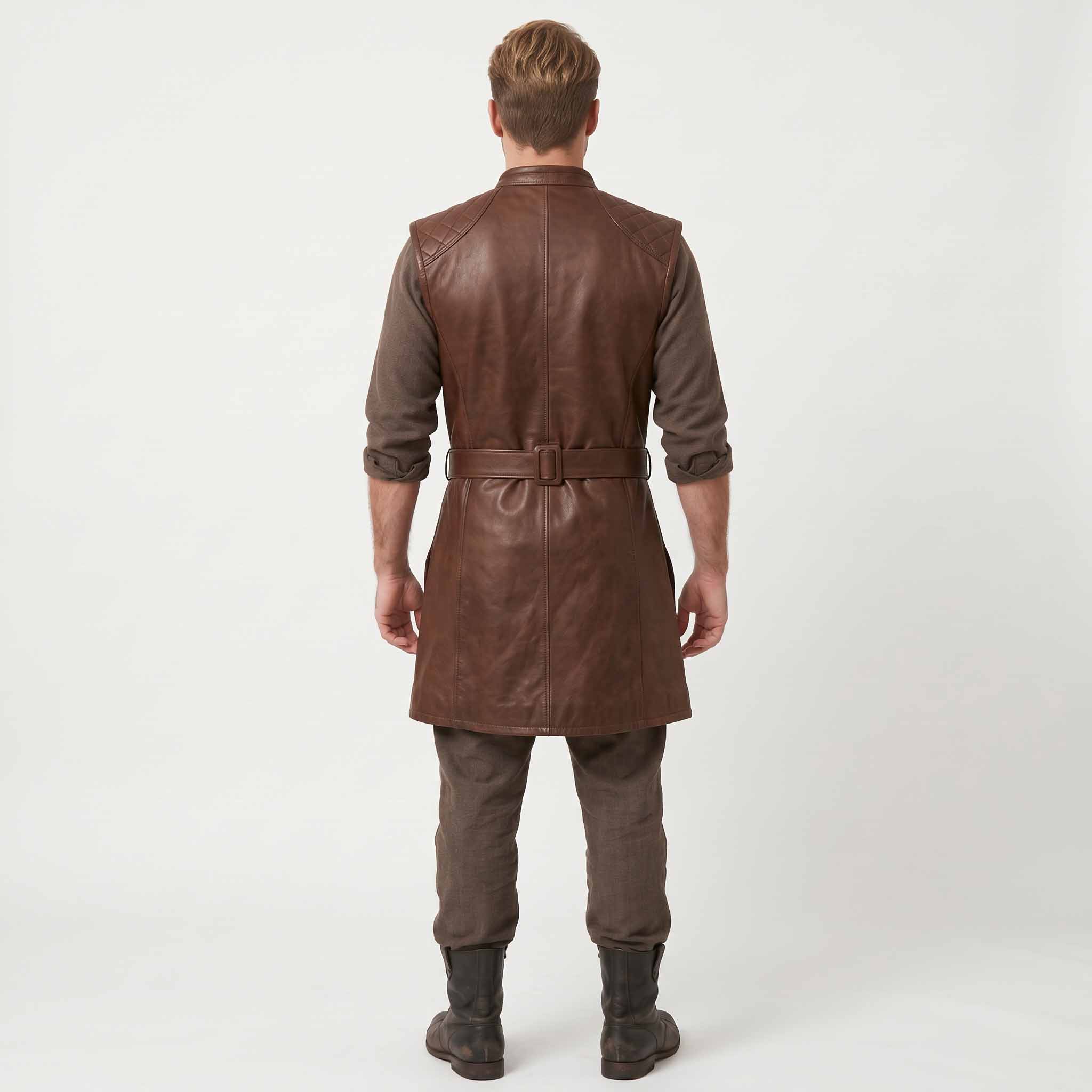 Full length rear studio view of blonde man wearing handcrafted brown leather medieval long jerkin paired with brown trousers and dark leather boots