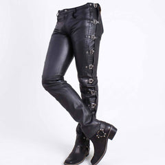 Three quarter perspective of woman wearing slim fit black leather buckle trousers paired with black harness biker boots