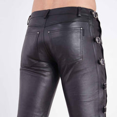 Back close up shot of fitted black leather trousers highlighting riveted rear patch pockets and side waist buckle strap