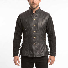 Front view of a man wearing a black real cowhide leather jerkin vest with antique brass buttons and lace-up sides over a black medieval tunic.