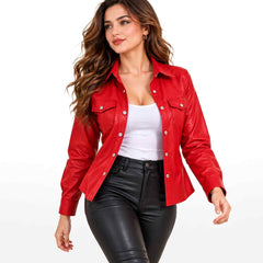 Full portrait of a model walking in an open red leather shacket paired with black leather trousers and a white camisole.