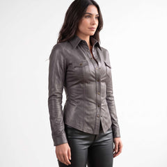 Three quarter side perspective highlighting the long sleeves, spread collar, and sleek profile of a women's gray leather blouse.
