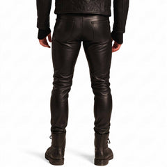 Back view of man wearing black leather biker jeans displaying dual spade back pockets, yoke seam, and form fitting seat