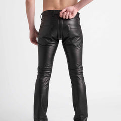 Rear view of man reaching behind back to unzip the functional rear seat zipper on black leather biker pants