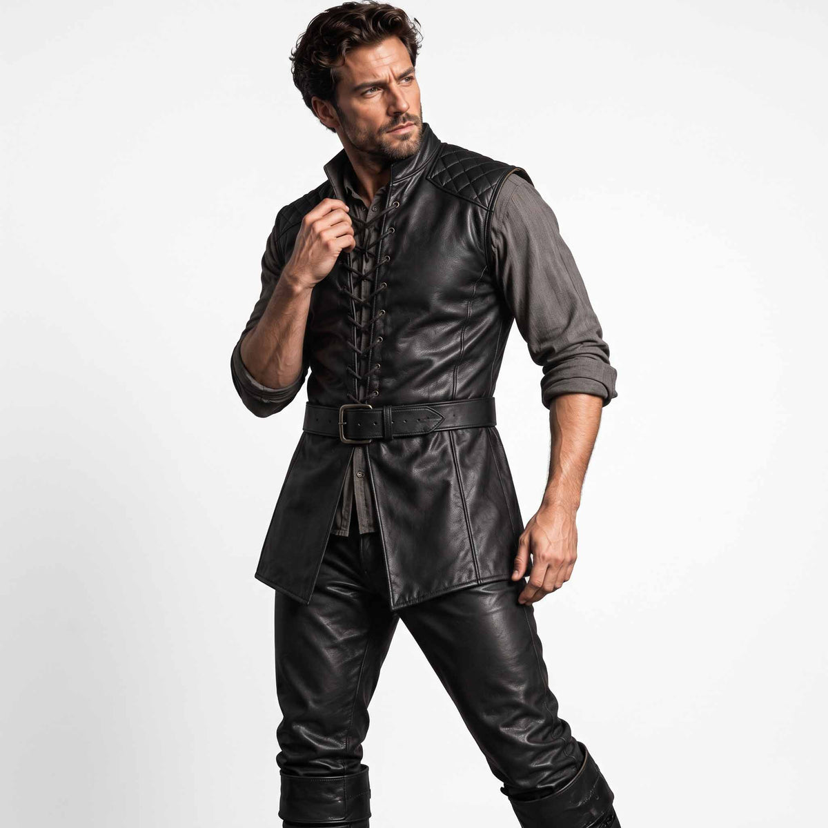 Full front shot of bearded man wearing handmade black sheepskin leather medieval jerkin with quilted shoulders, front lacing, and waist belt