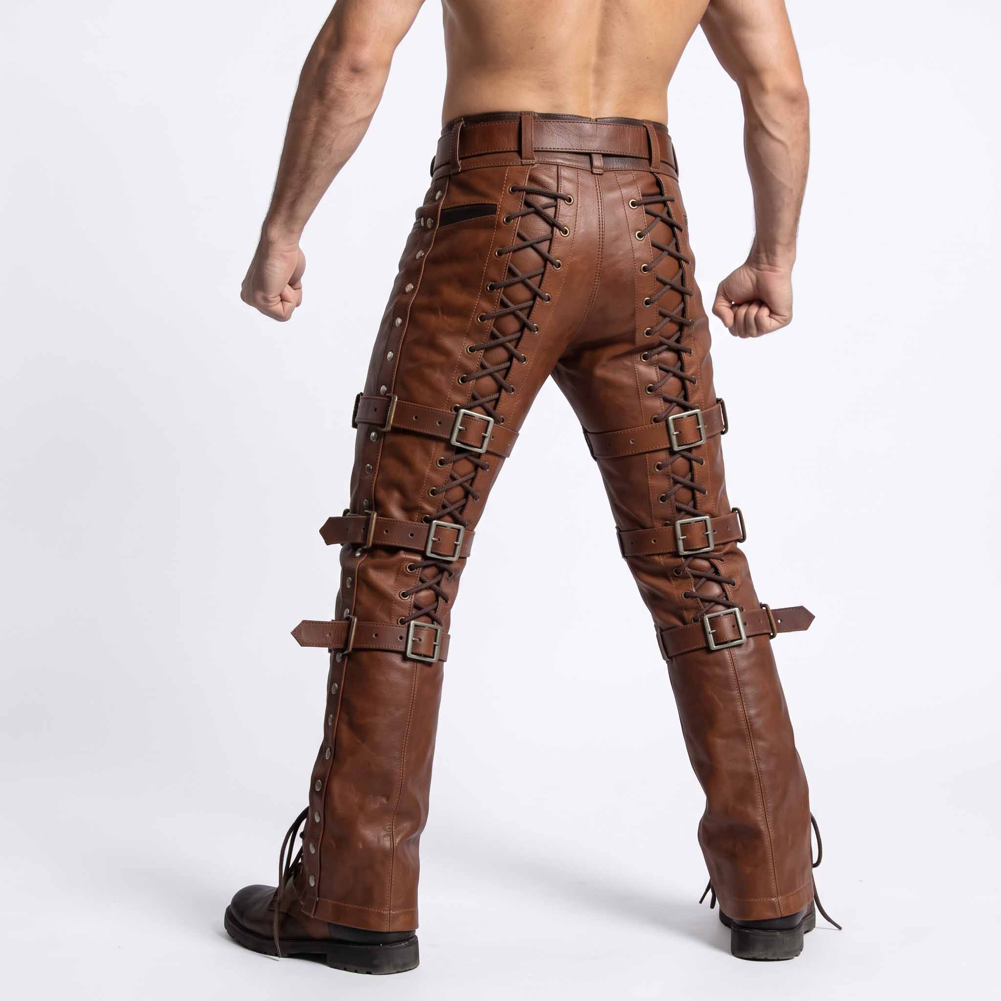 Back studio view of man wearing brown genuine leather pants displaying continuous rear leg corset lacing and horizontal buckle straps