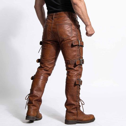 Rear three quarter angle of man modeling brown cowhide leather biker trousers showing riveted back pockets and outer leg buckle straps
