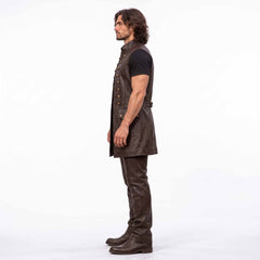 Side profile 90 degree view of man wearing tailored long brown leather medieval waistcoat showing armhole cut and flap pocket