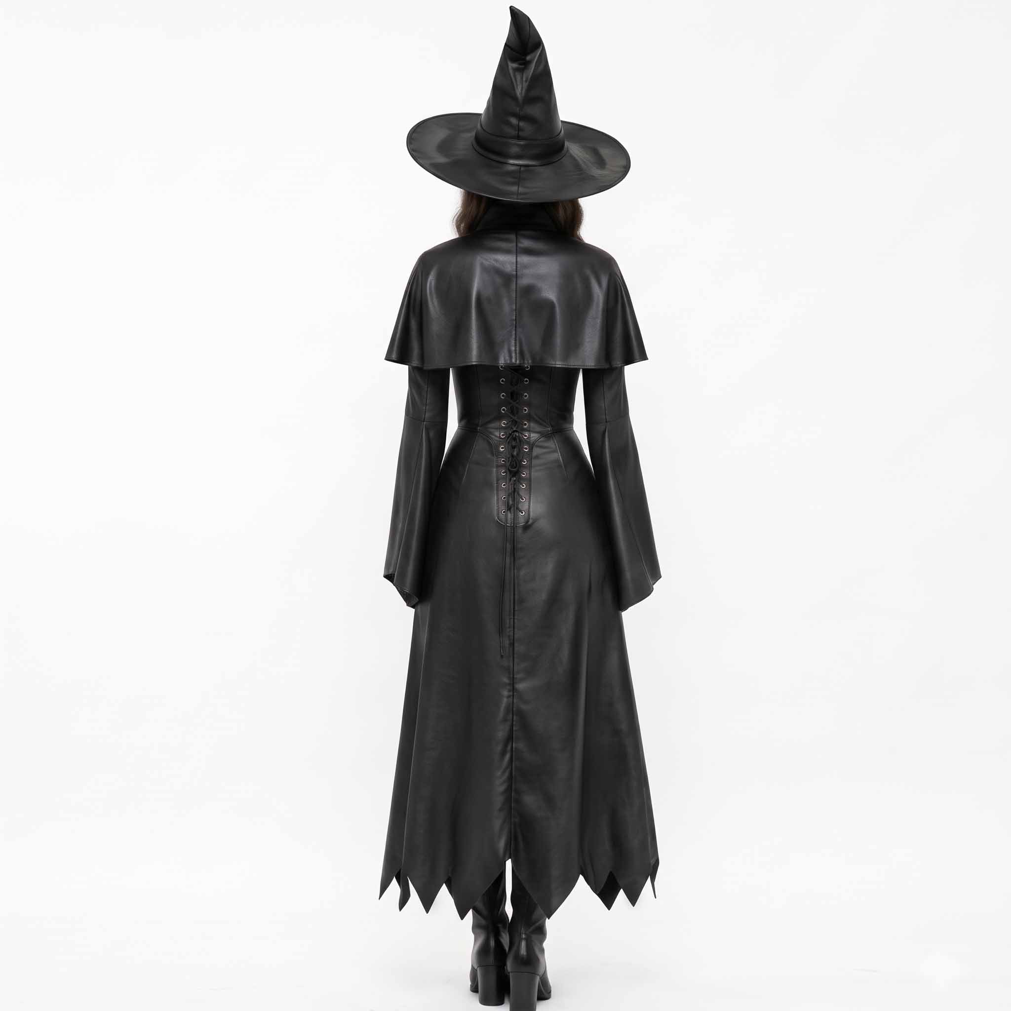 Rear view of the black leather witch costume showing the fitted lace-up corset back detail, matching capelet, and pointed brim witch hat.