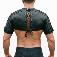 Direct back view of muscular man wearing black leather festival shrug showing spine corset lacing and bicep buckle straps
