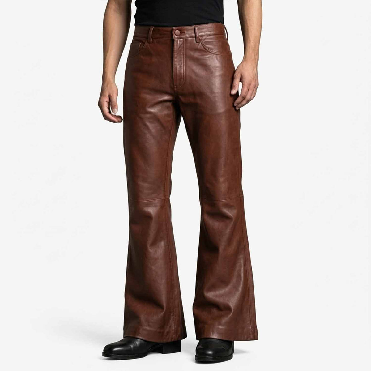 Front view of a man wearing brown genuine lambskin leather bell bottom pants with a high waist and wide flared hem.
