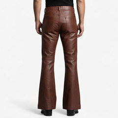 Rear view showcasing the clean back pockets, high waist cut, and wide flared leg opening on black leather trousers.