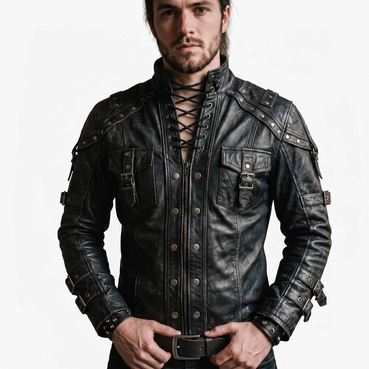 Front view of handsome man wearing handmade black leather gothic shirt jacket featuring lace up neck collar, front zipper placket with metal dome rivets, and buckled chest pockets