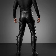 Back view of man wearing tailored black leather renaissance trousers showing reinforced saddle seat seams and buckled calf strap closures