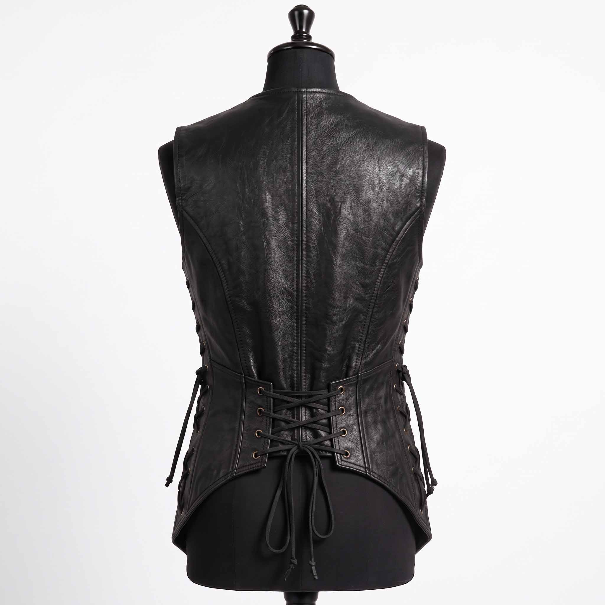 Back studio shot of black leather medieval doublet showing curved spine seams, side eyelet cords, and lower back corset ties