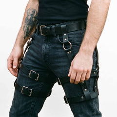 Close up front shot of adjustable double band black leather thigh harness detailing silver roller buckles and welded metal O rings