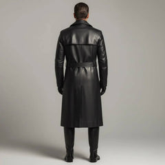 Full length front view of man wearing double-breasted black leather trench coat open over black turtleneck with leather trousers