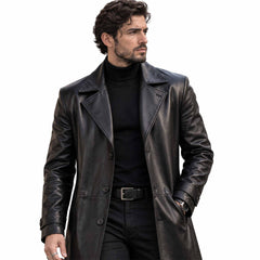 Close up portrait of man wearing black genuine leather longline coat highlighting wide notched lapels, button placket, and tailored sleeve cuffs