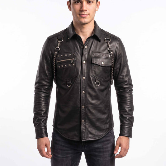 Full front view of handsome young man wearing handmade black sheepskin leather shirt with silver studs, shoulder chains, and snap button placket