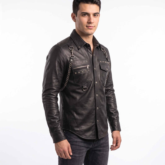 Front three quarter perspective of man modeling black leather gothic punk shirt showing chest zip pocket, hanging D rings, and shoulder chain harness