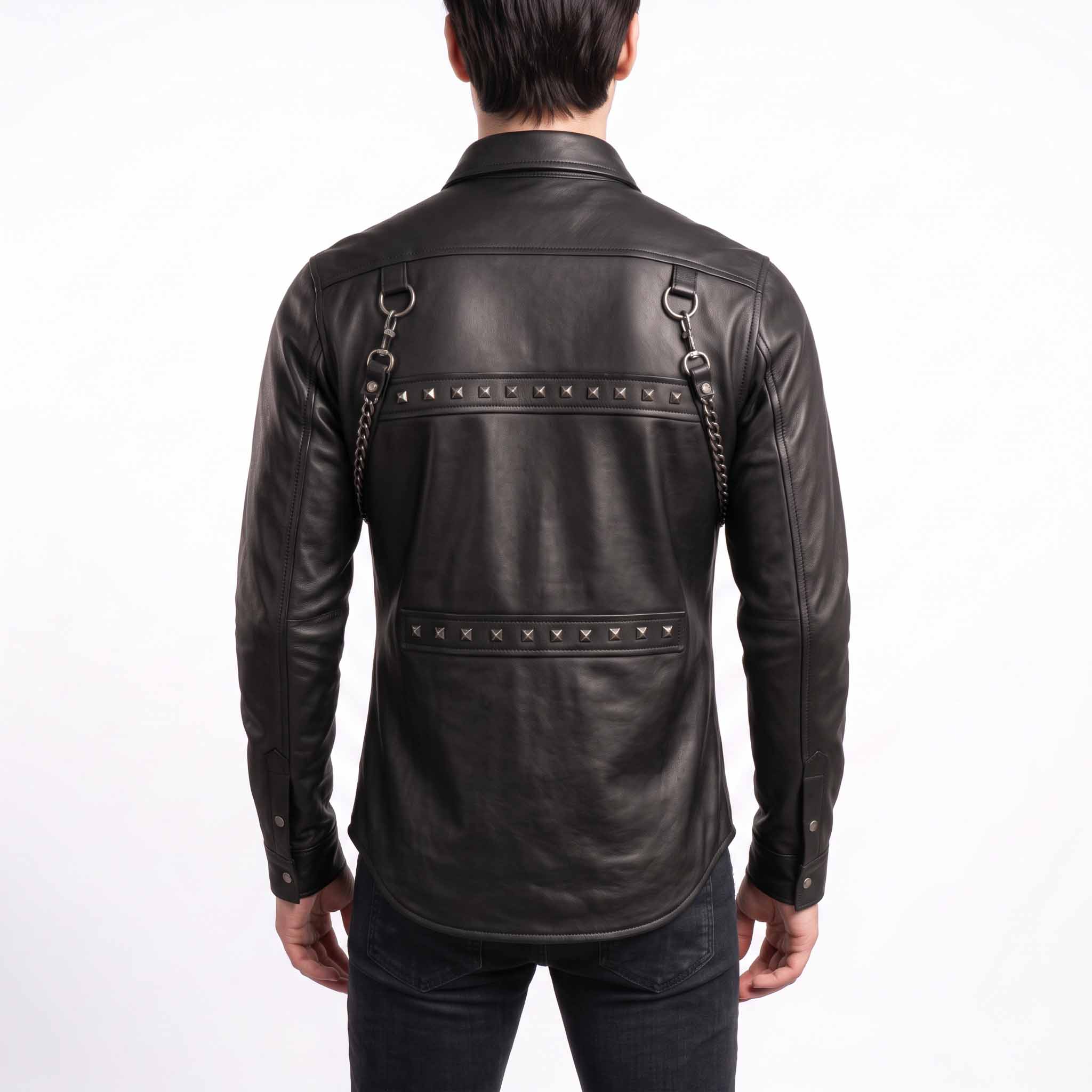 Back view of man wearing black genuine leather rocker shirt displaying dual horizontal panels with pyramid studs and back shoulder D rings with chains