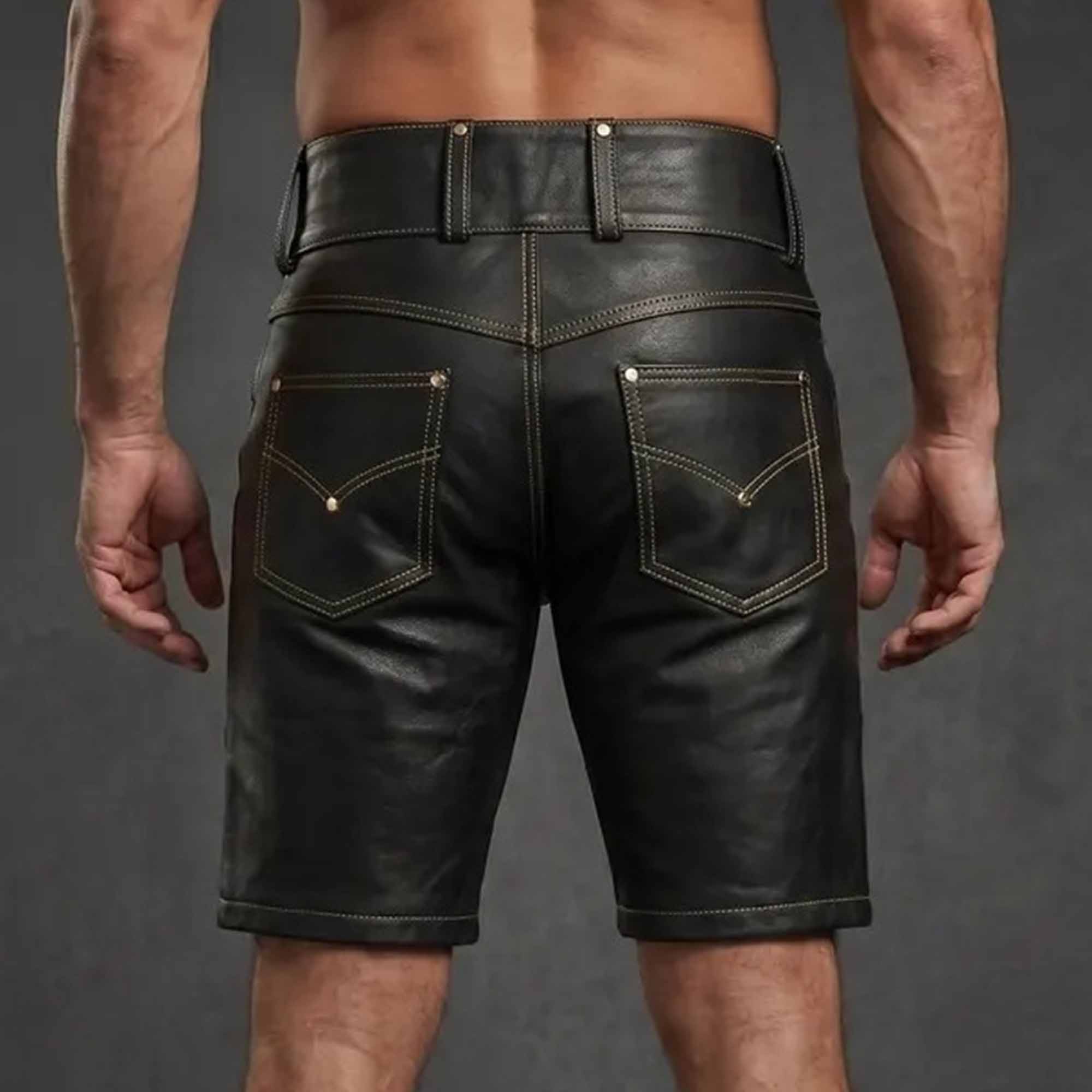 Rear view of tailored black leather shorts showing dual back pockets with chevron stitching, wide belt loops, and smooth cowhide finish.