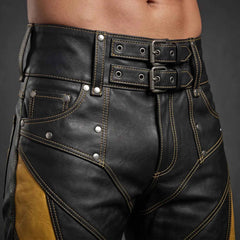 Macro detail shot of the high-rise waistband on black leather shorts highlighting the dual metal roller buckles, grommets, and coin pocket rivets.