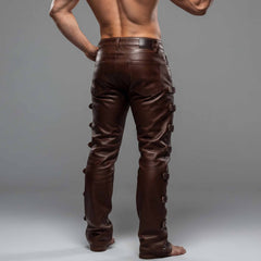 Rear view of man wearing brown genuine leather pants displaying five-pocket jean styling, reinforced back seams, and side buckles
