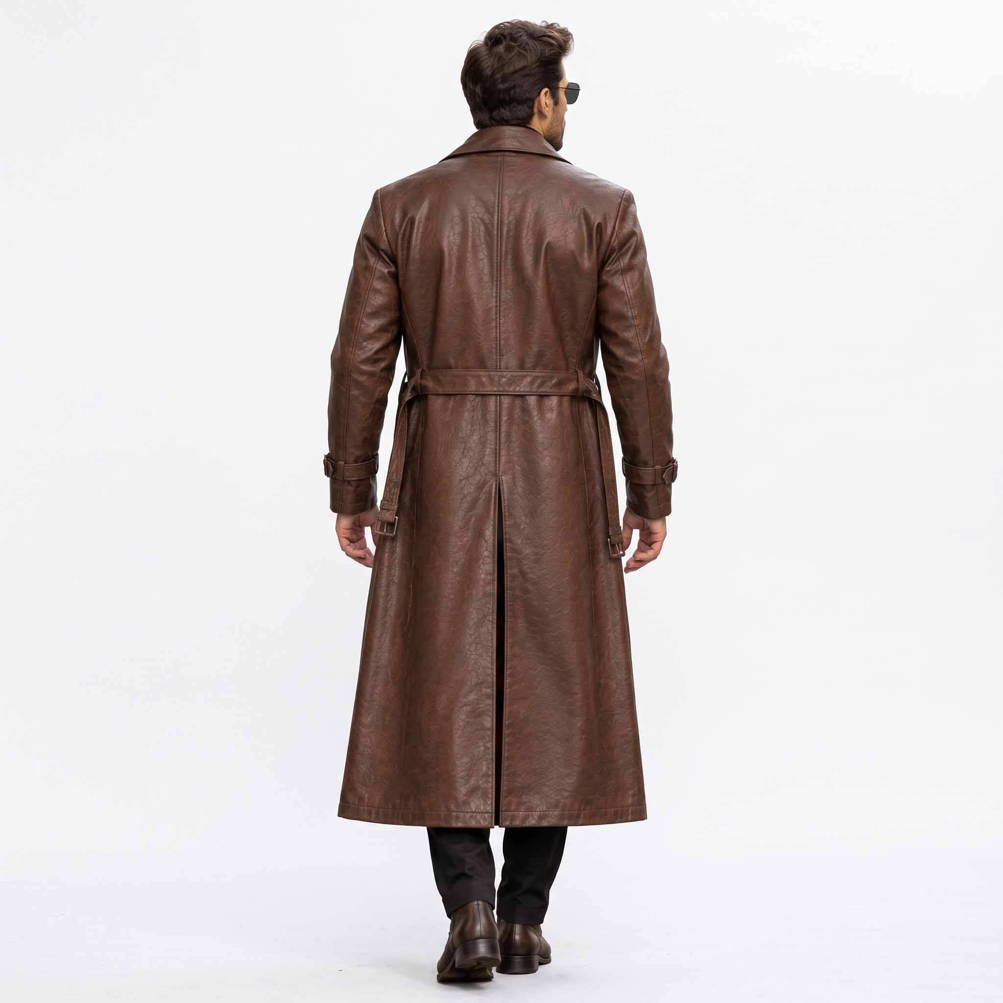 Back full length studio view of mens brown leather duster coat showing tailored vertical back seams and deep center split walking vent