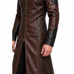Close up view of brown cowhide leather coat detailing heavy duty front zipper, slanted zippered pocket, and black leather cuff panel