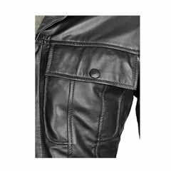 Close-up view of the snap-button chest flap pocket and double-stitched seams on a black lambskin leather jacket.