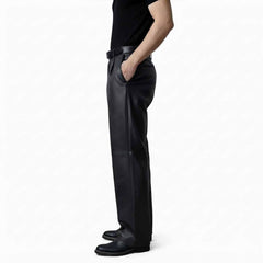 Side profile view of men's black leather dress pants showing the comfortable regular fit and clean side pocket styling.