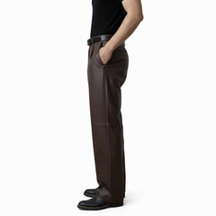 Side profile view of men's brown leather dress pants showing the comfortable regular fit and clean side pocket styling.