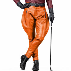 Bold orange men's leather jodhpurs featuring metal zipper pockets and a smooth genuine leather finish.
