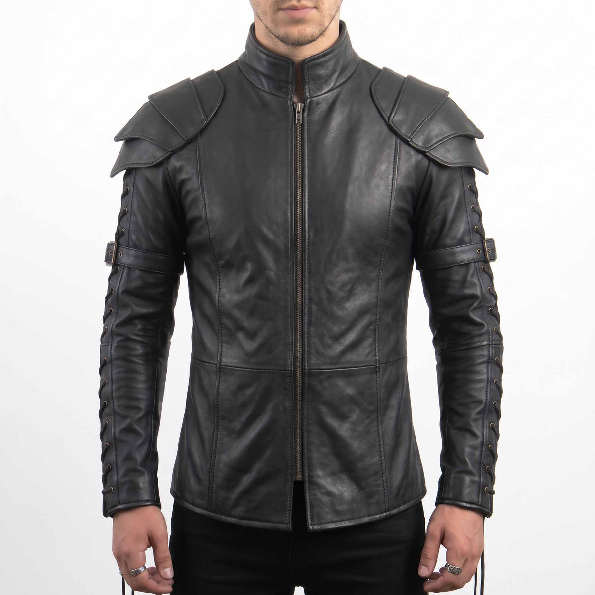 Front torso shot of male model wearing handmade gothic black cowhide leather armor shirt with center zip, tiered shoulder pauldrons, and lace-up sleeves