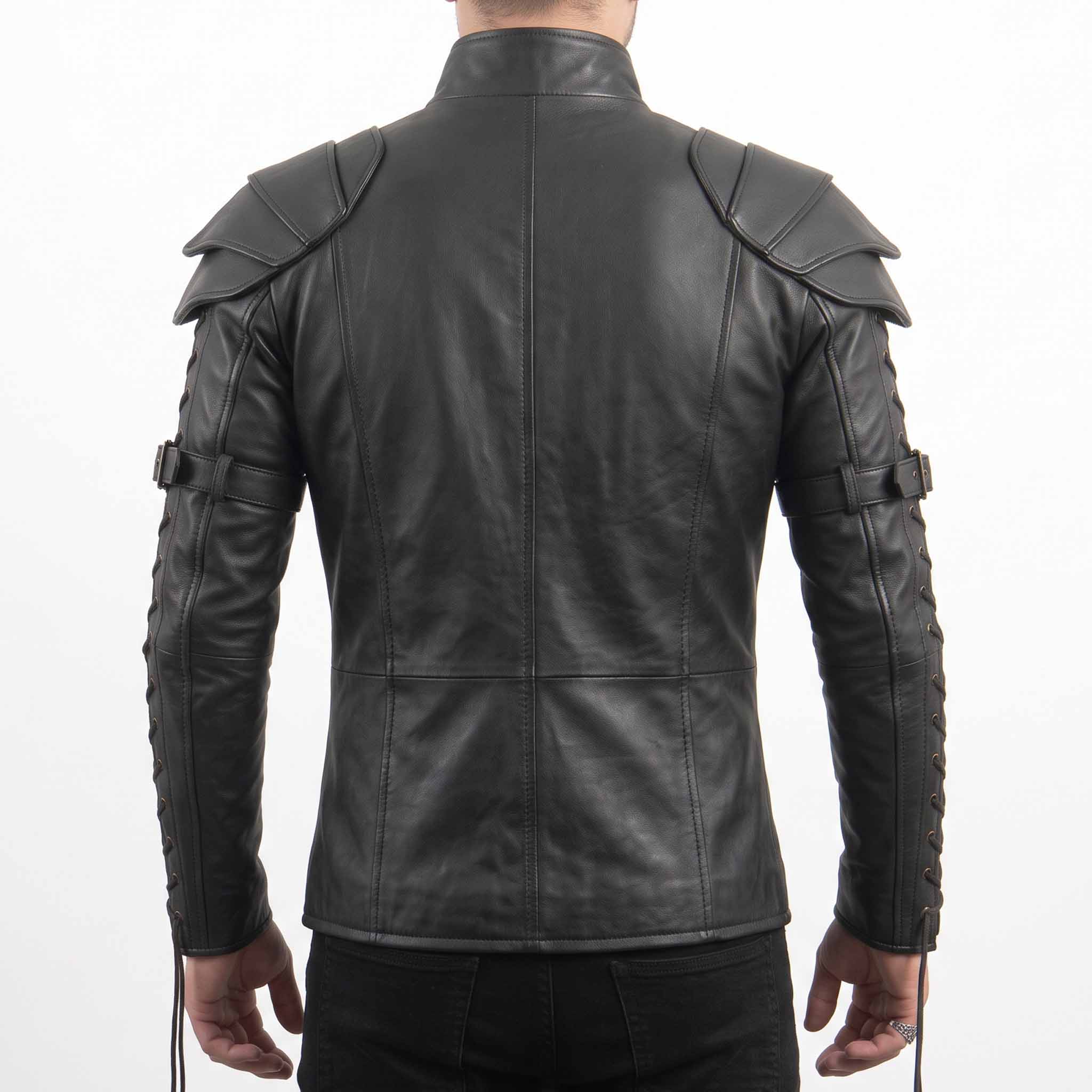 Direct back view of man wearing black leather steampunk tactical shirt showing tiered shoulder plates, mandarin collar, and tailored back seams
