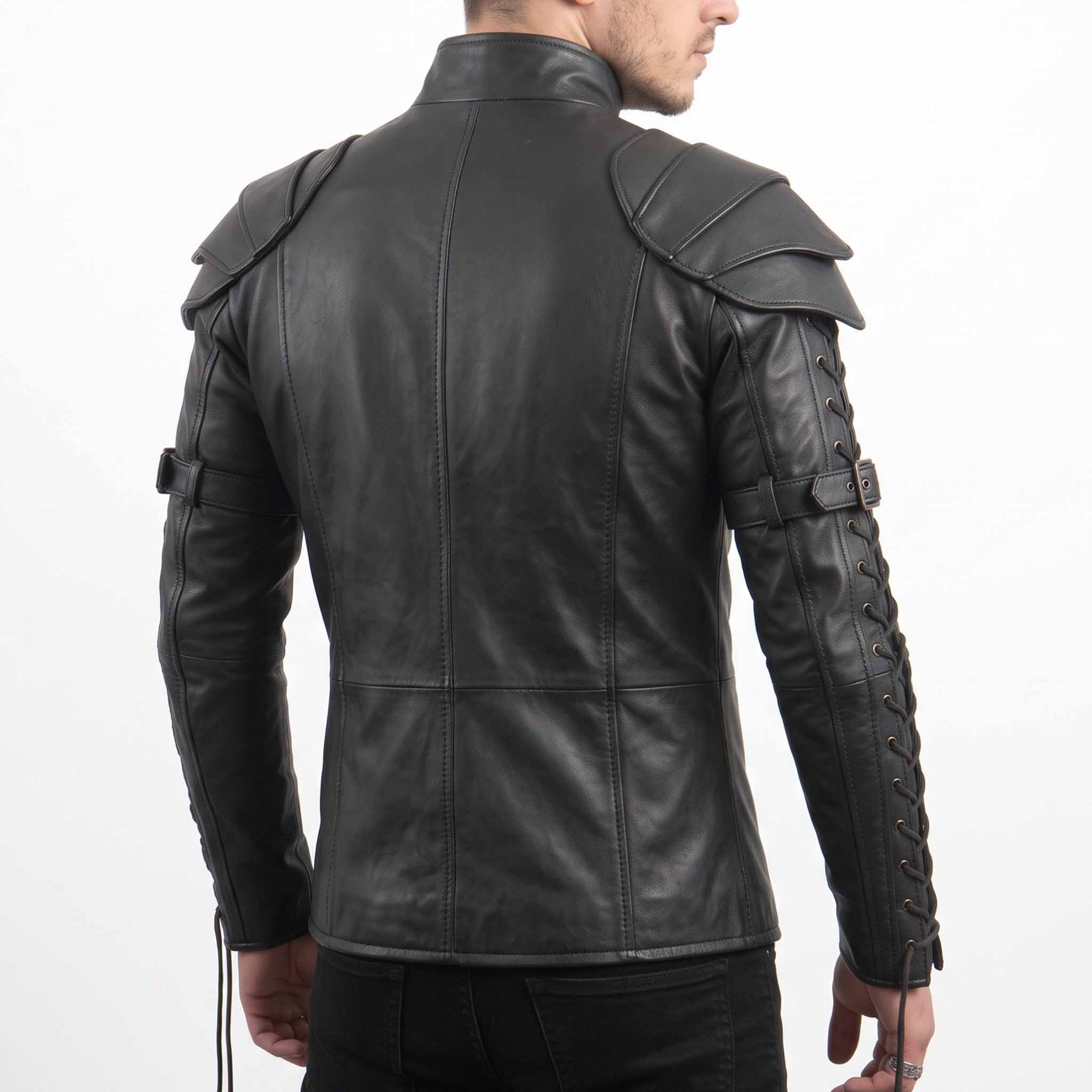 Rear three-quarter perspective of male model modeling black genuine cowhide leather armor top detailing bicep buckle straps and sleeve cord lacing