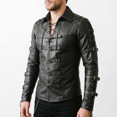 Three quarter perspective of man in black tactical leather armor shirt highlighting chest roller buckles and segmented arm cord lacing