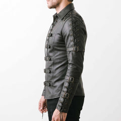 Side profile 90 degree studio shot of fitted black leather gothic shirt showing bicep and forearm buckle straps with eyelet cords